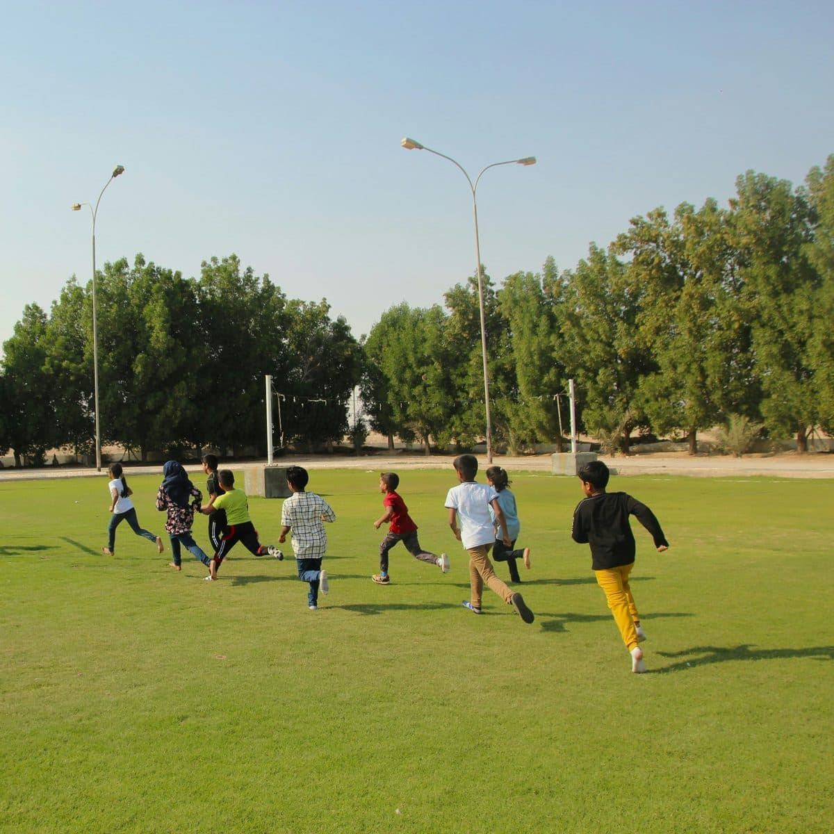 Children playing football together outdoors